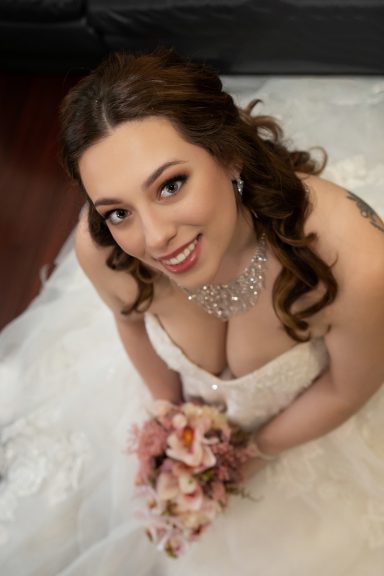 bride fully dressed looking up into camera